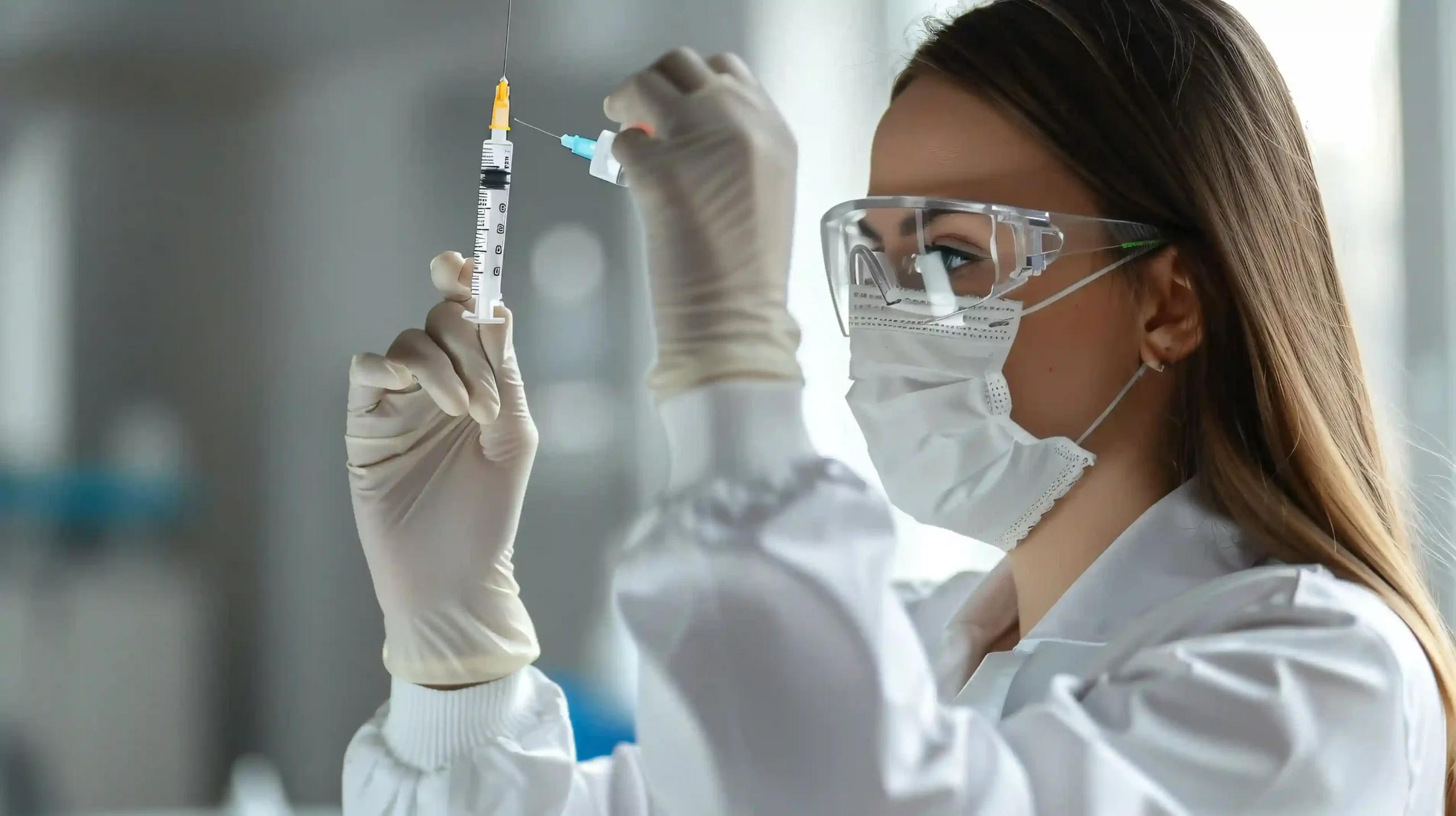 Scientist holding syringe